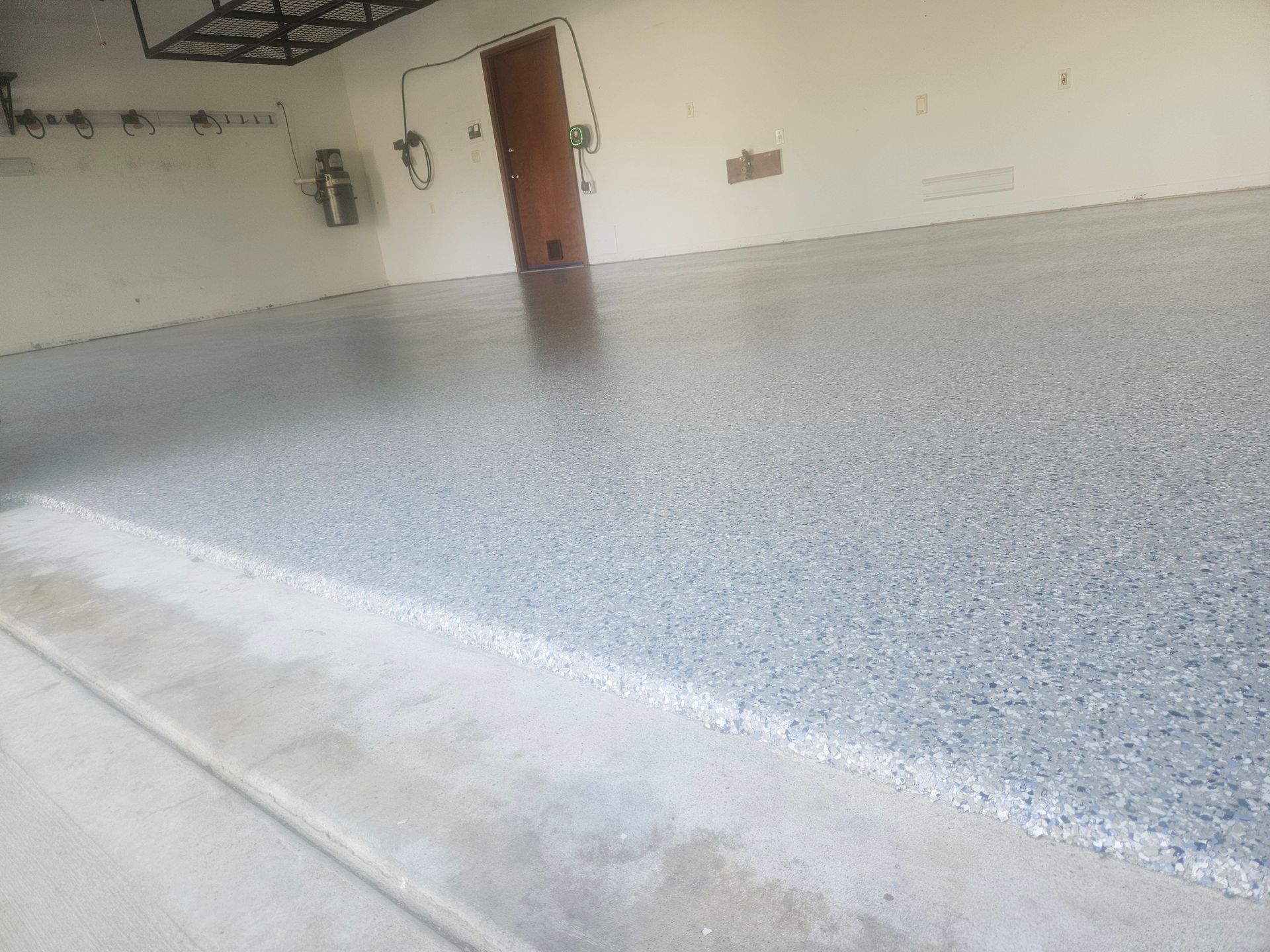 A garage with a gray floor and white walls.