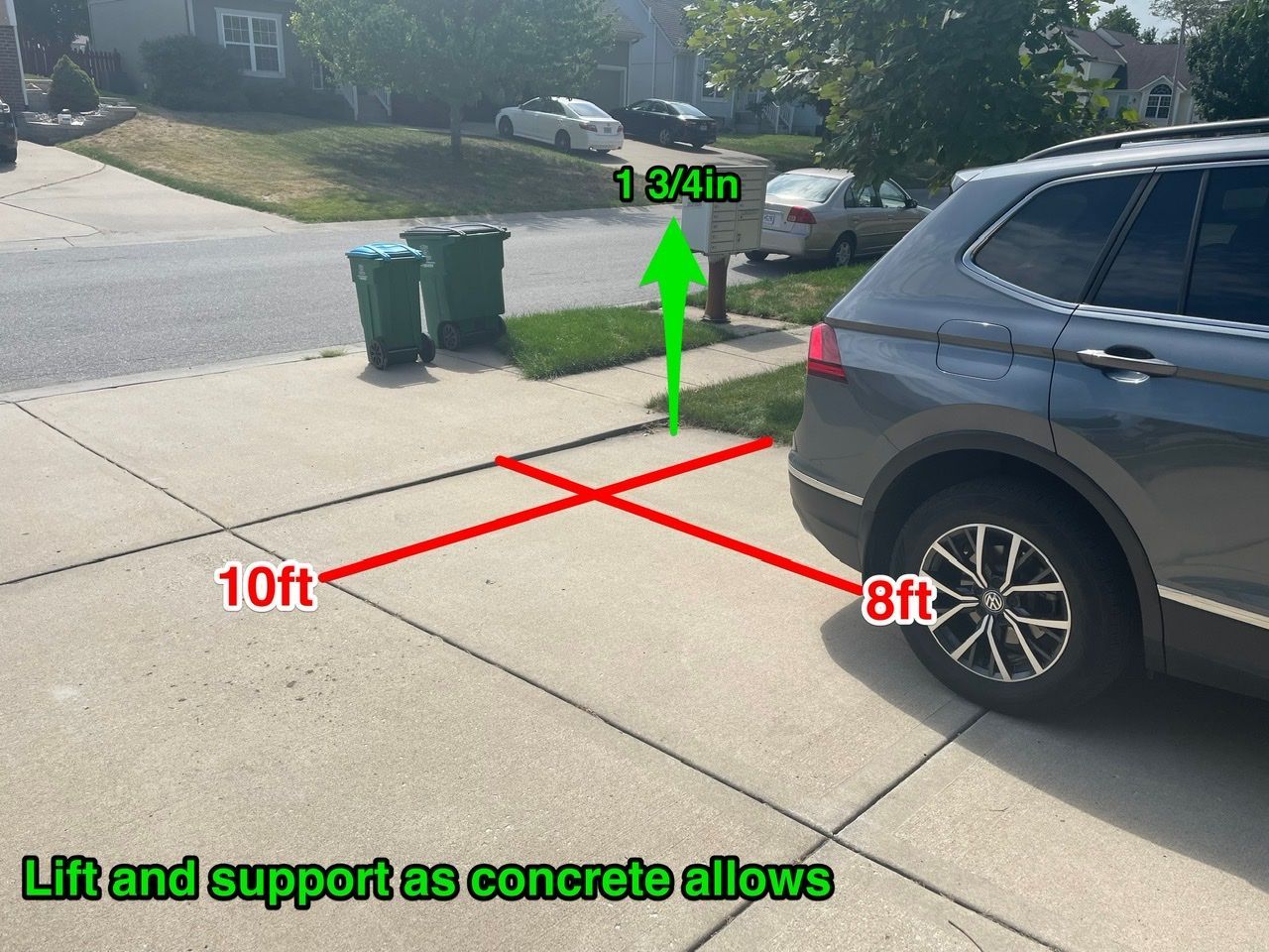 A car is parked on a concrete driveway that says lift and support as concrete allows