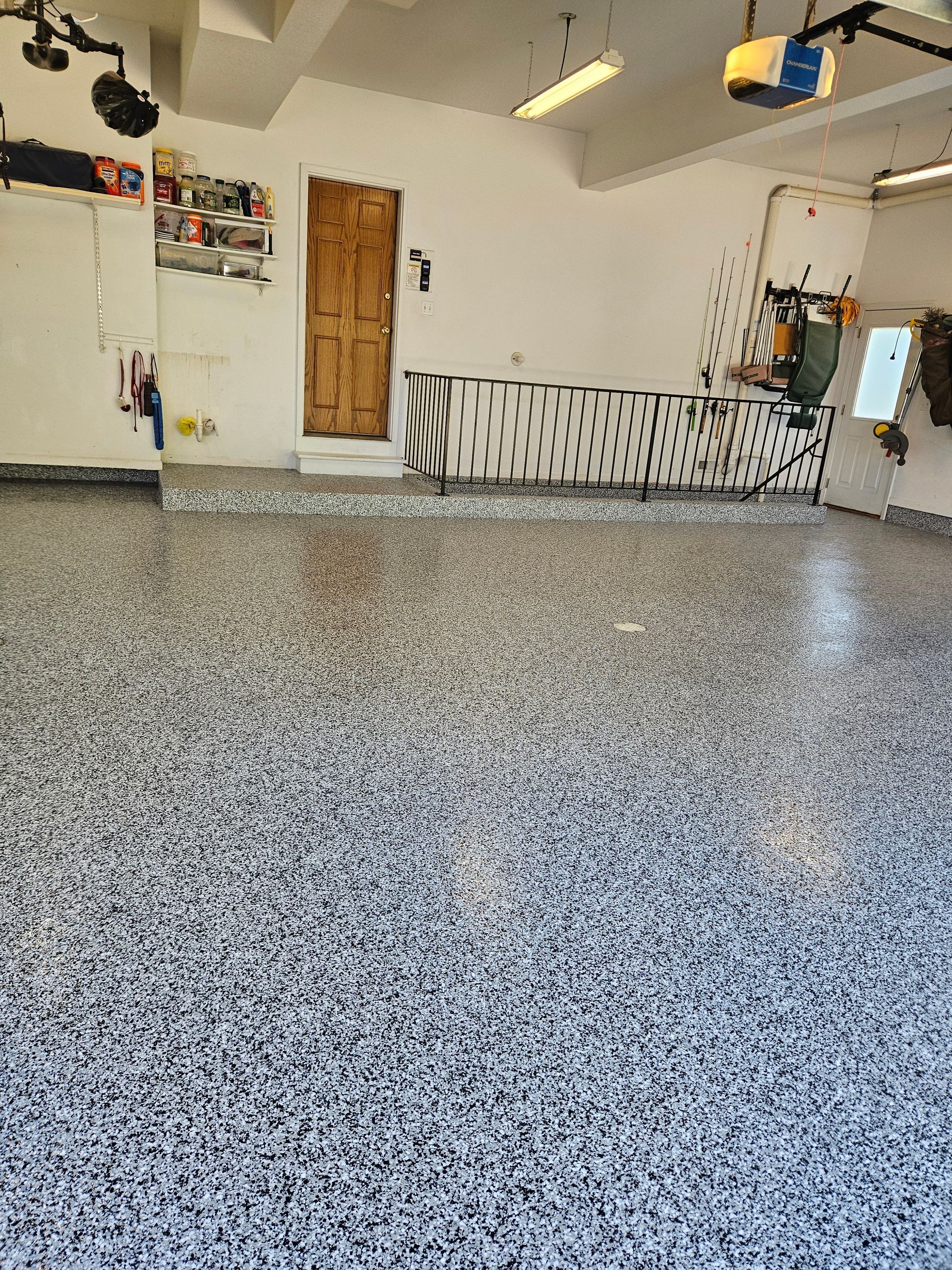 A garage with a gray floor and white walls.