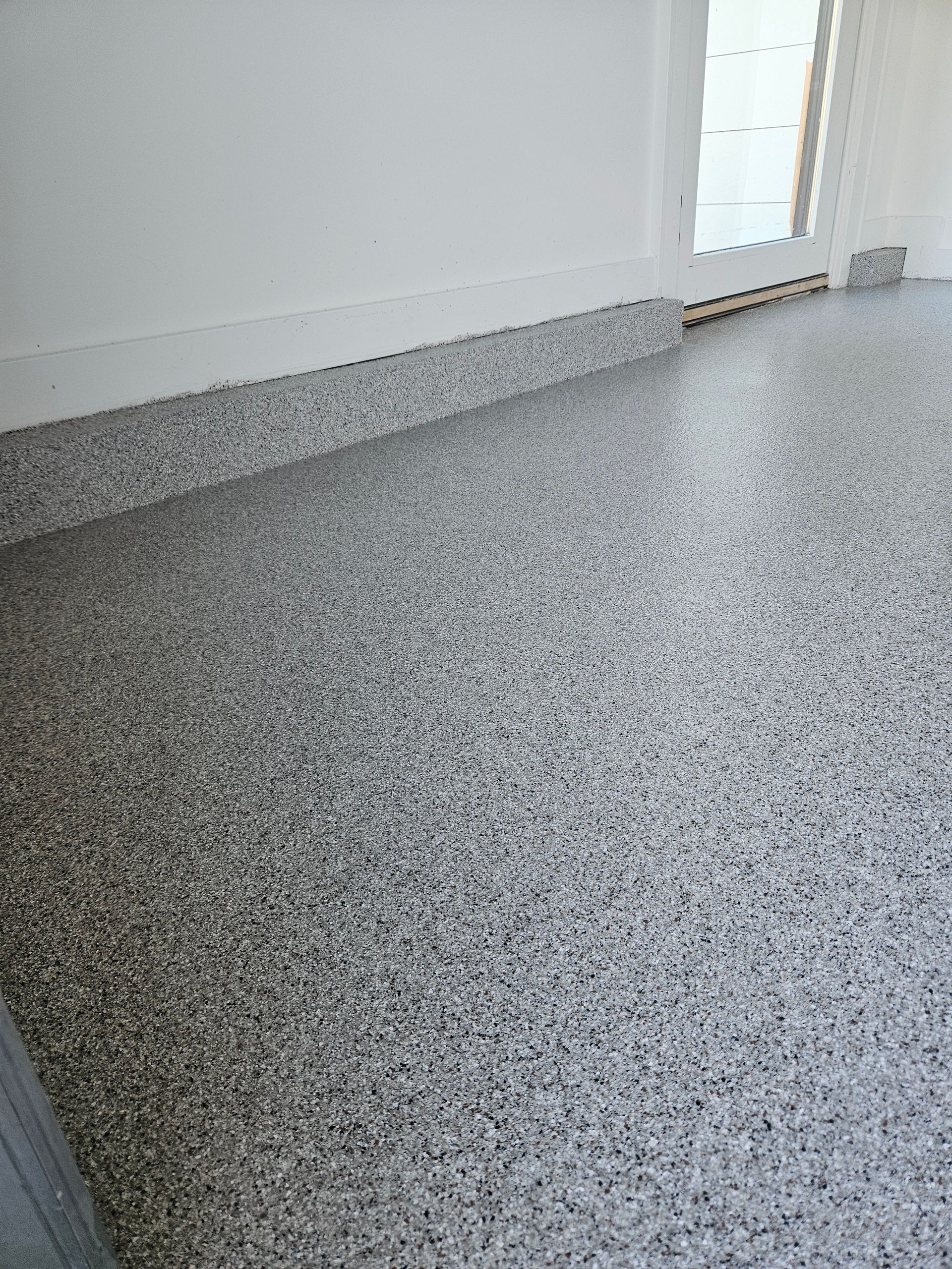 A close up of a gray concrete floor in a room.