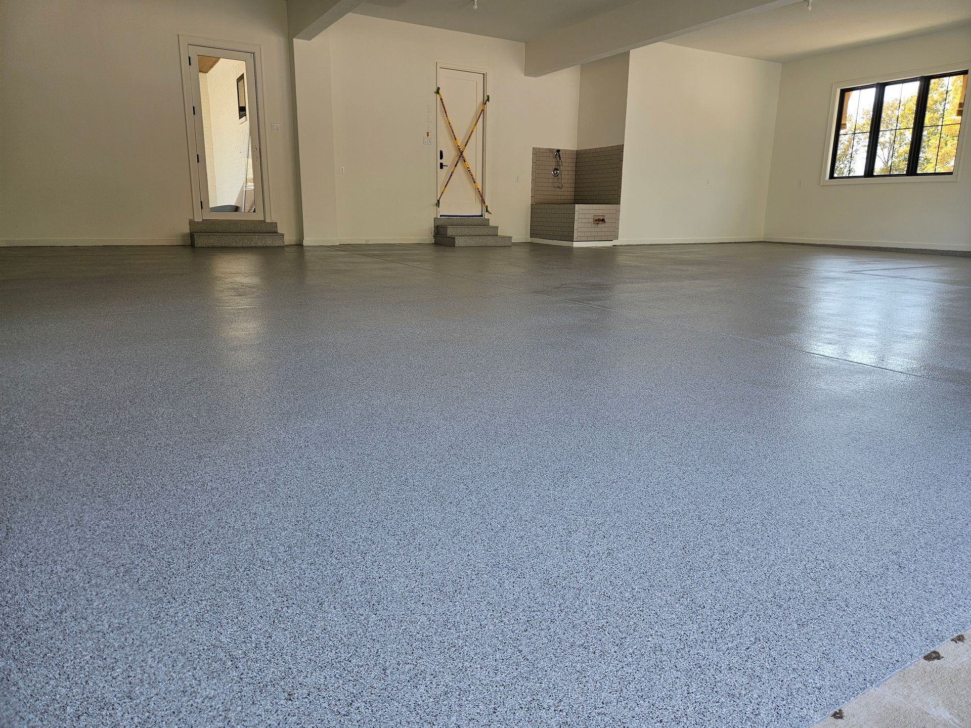 A large room with a gray floor and white walls