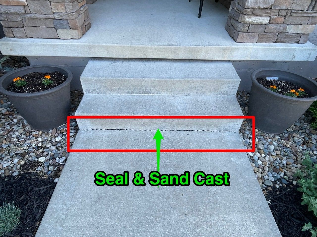 A concrete walkway with the words seal and sand cast on it