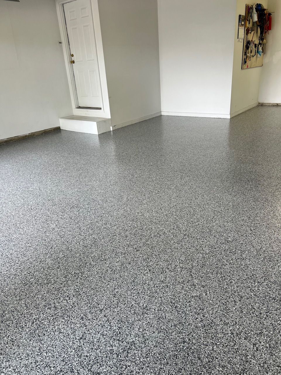 A room with a gray floor and white walls.