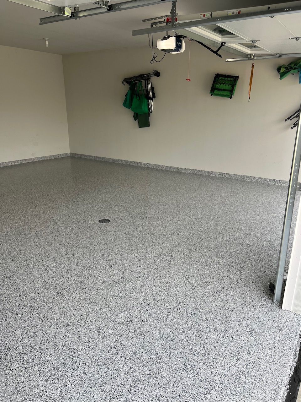 A garage with a gray floor and white walls.