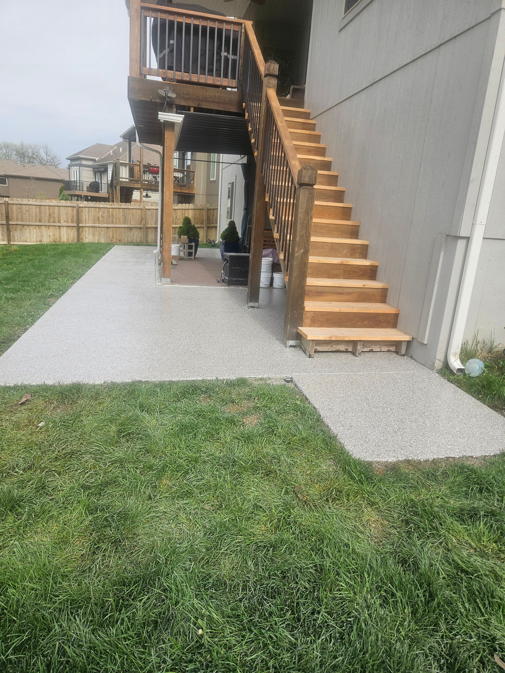 A house with a deck and stairs leading up to it.
