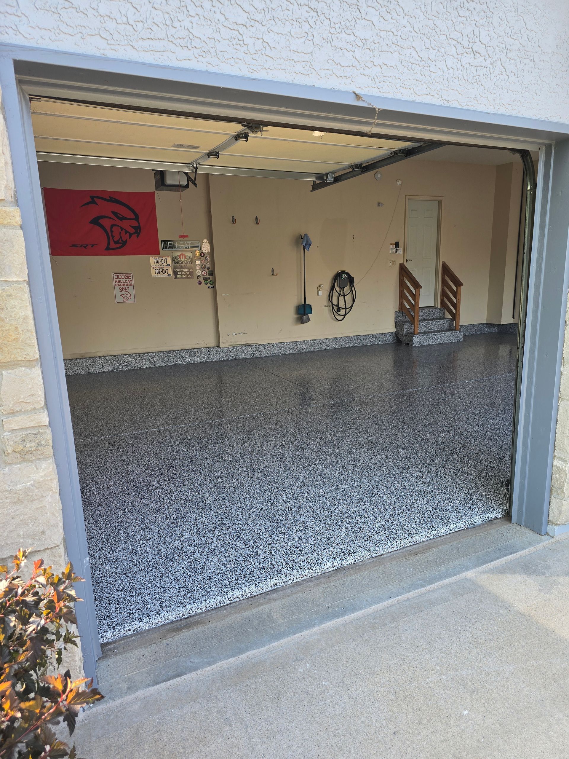 A garage with a flag on the wall and a flag on the floor.