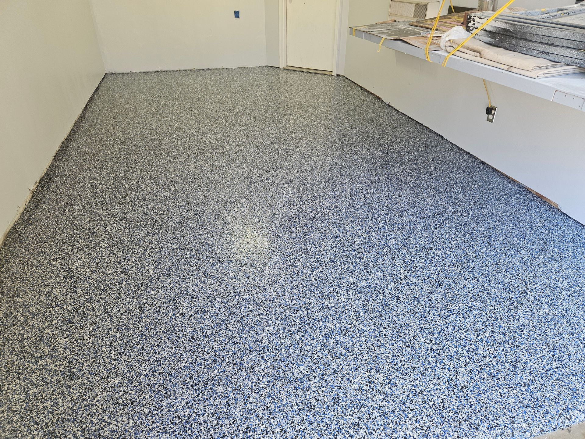 A large room with a gray and white marble floor.