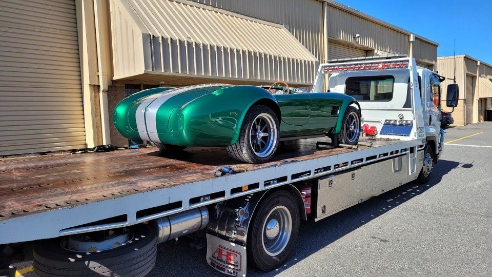 view of a green car being transported