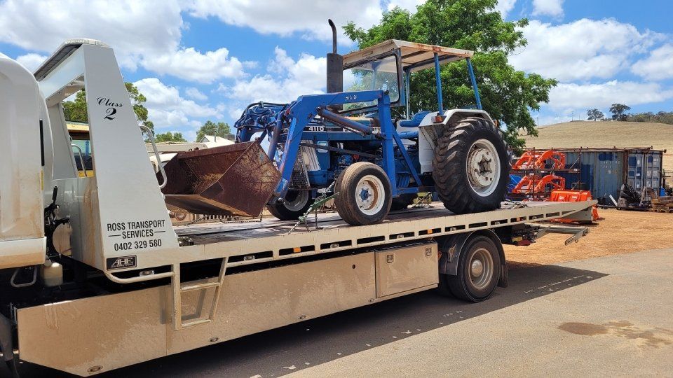 transporting a blue colour earth moving machine