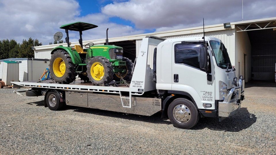 tractor on a flat bed tow truck