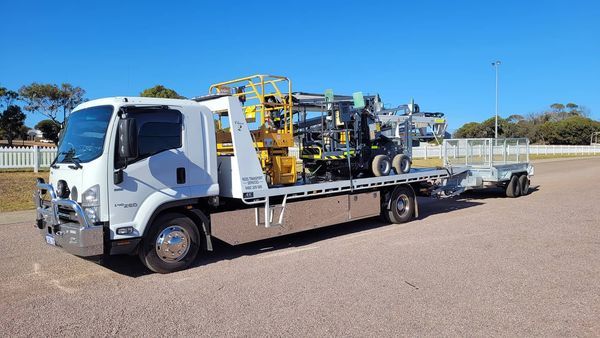 side view of a heavy equipment being  transported