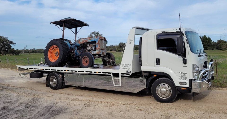 side view of tractor being transported