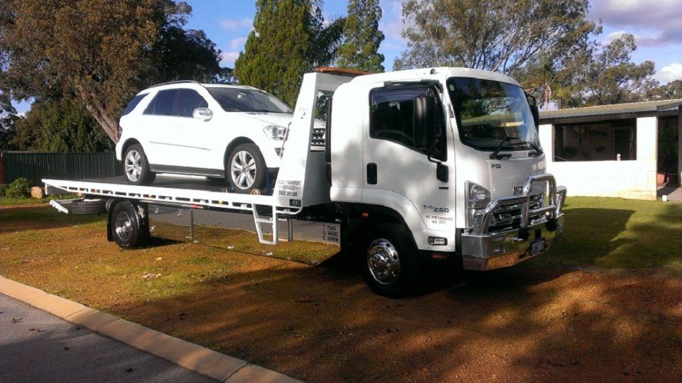view of a white car being transported