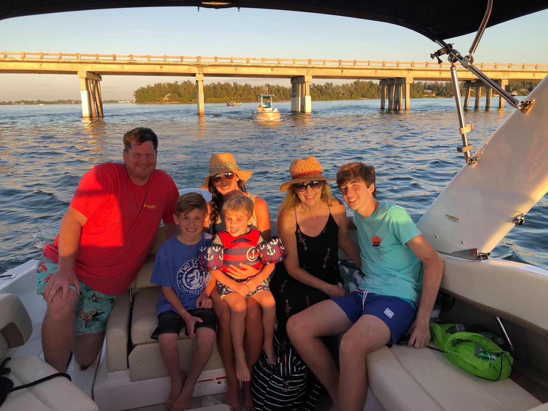 Photo of a family during sunset with bridge behind