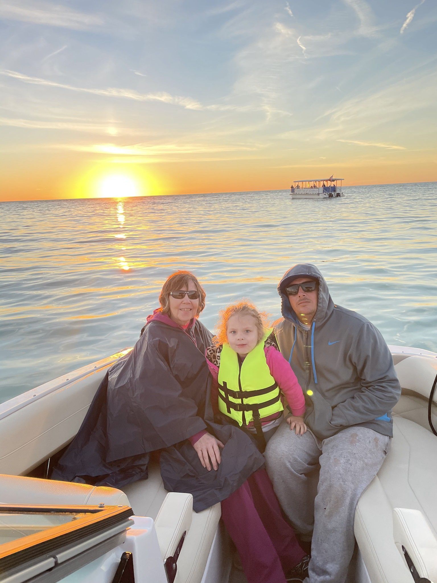 Family with sunset behind