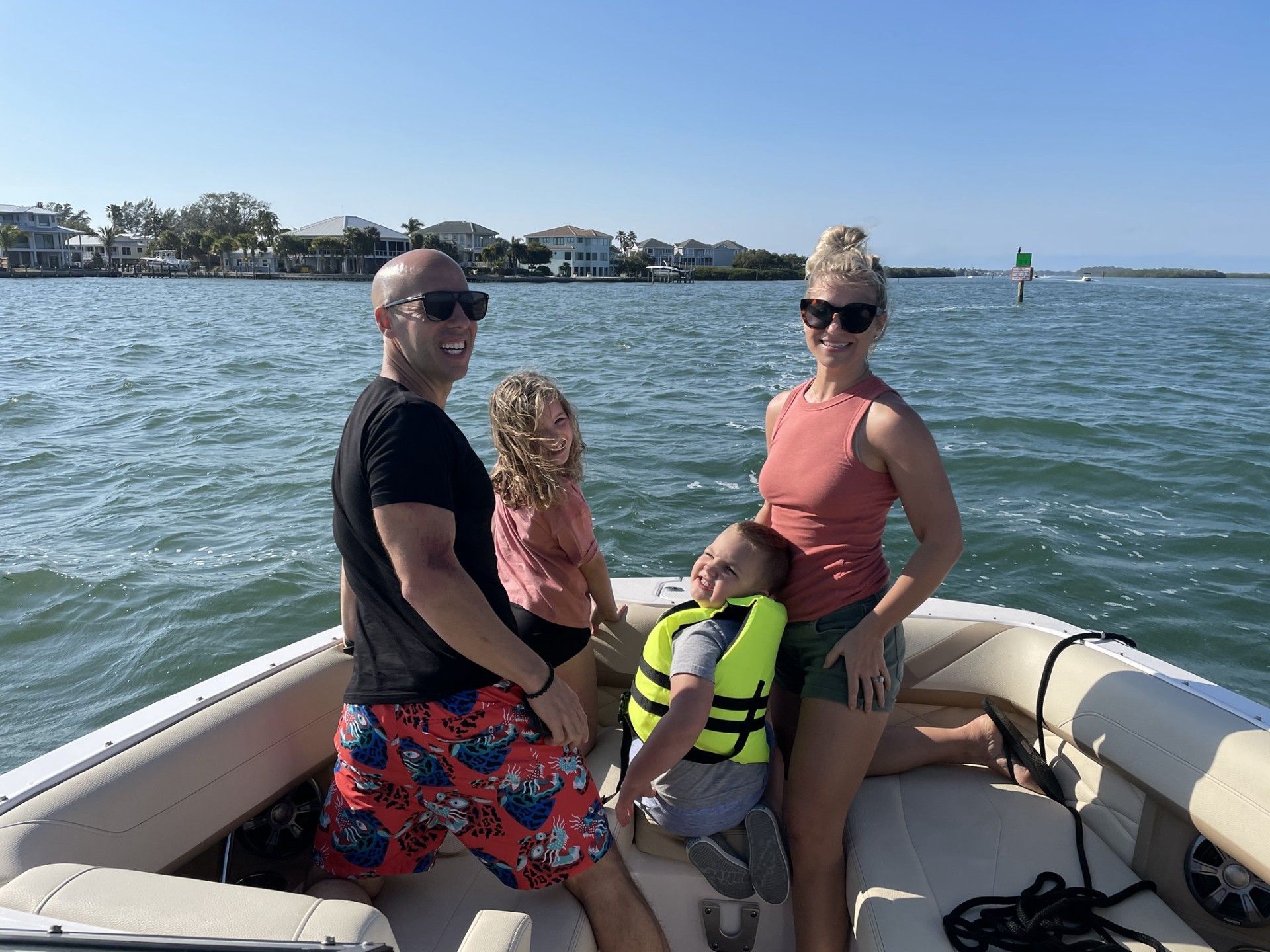 A family is sitting on a boat