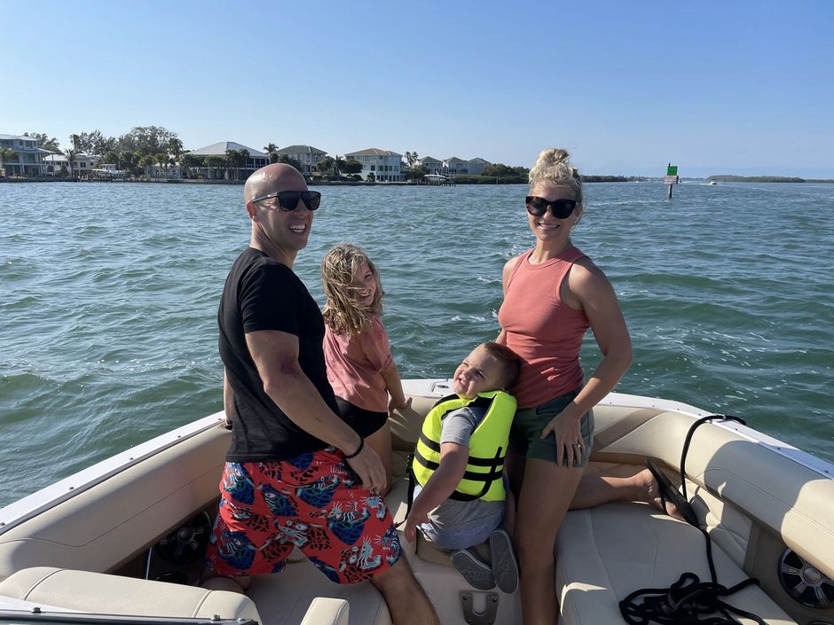 A family is sitting on a boat