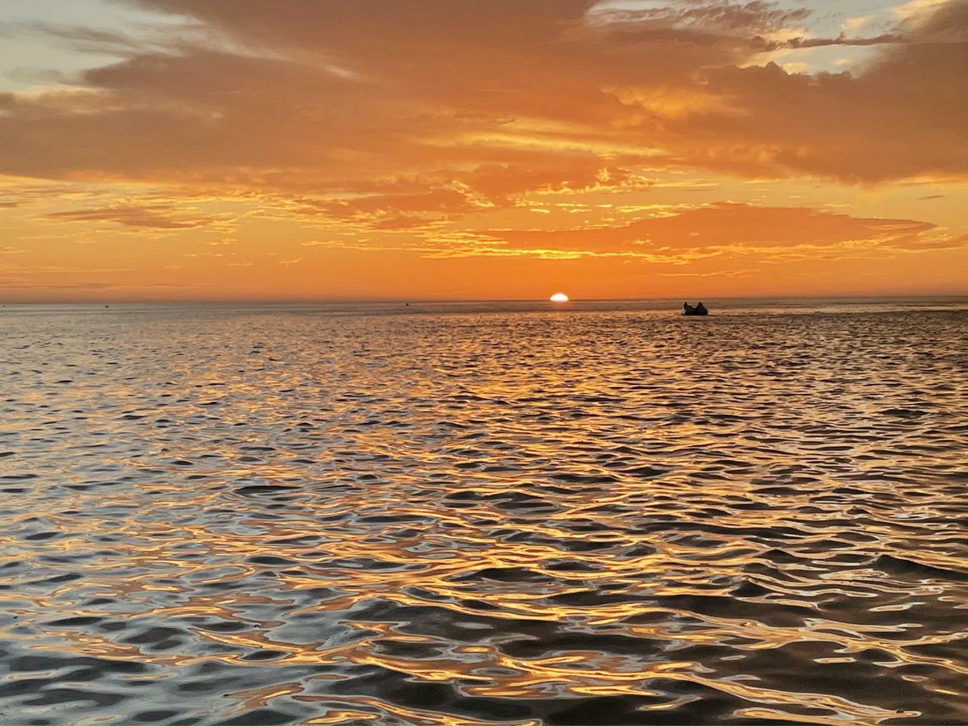 An orange sunset on the water