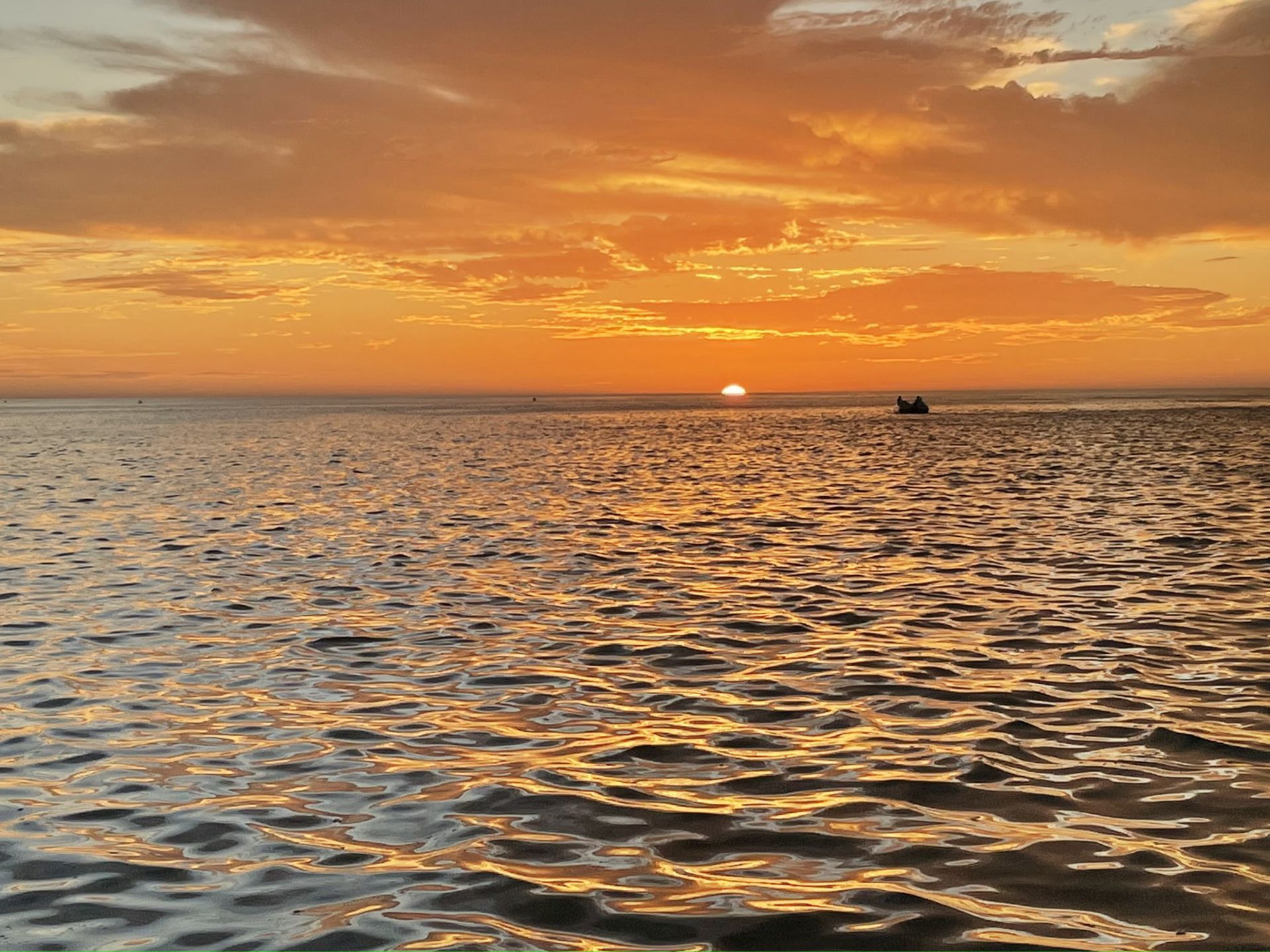 The orange sunset along the ocean