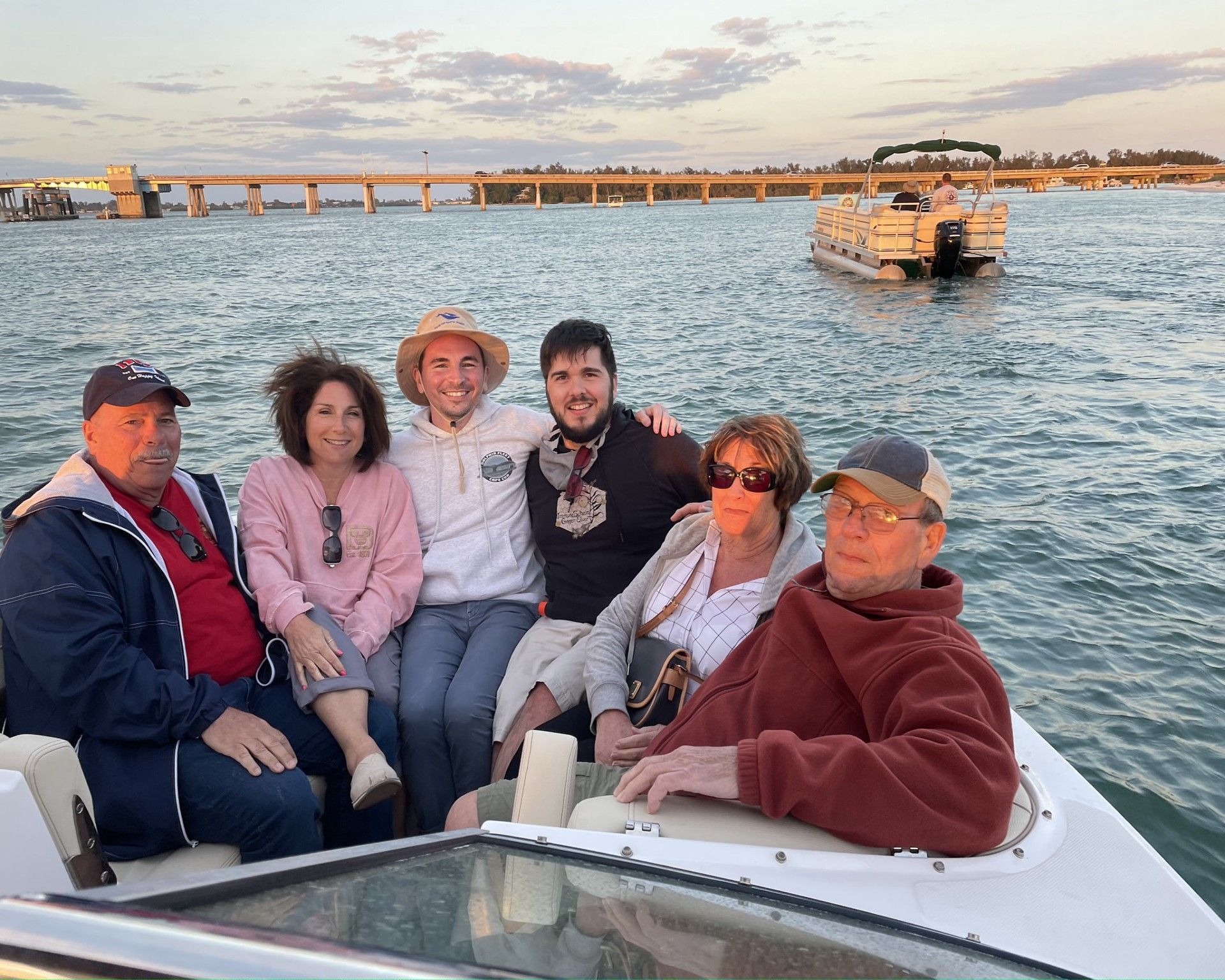 Senior tourist enjoying the sunset while sitting on the boat