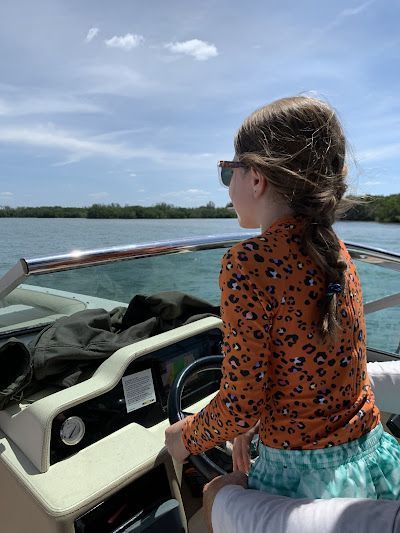 A child 'drives' a boat