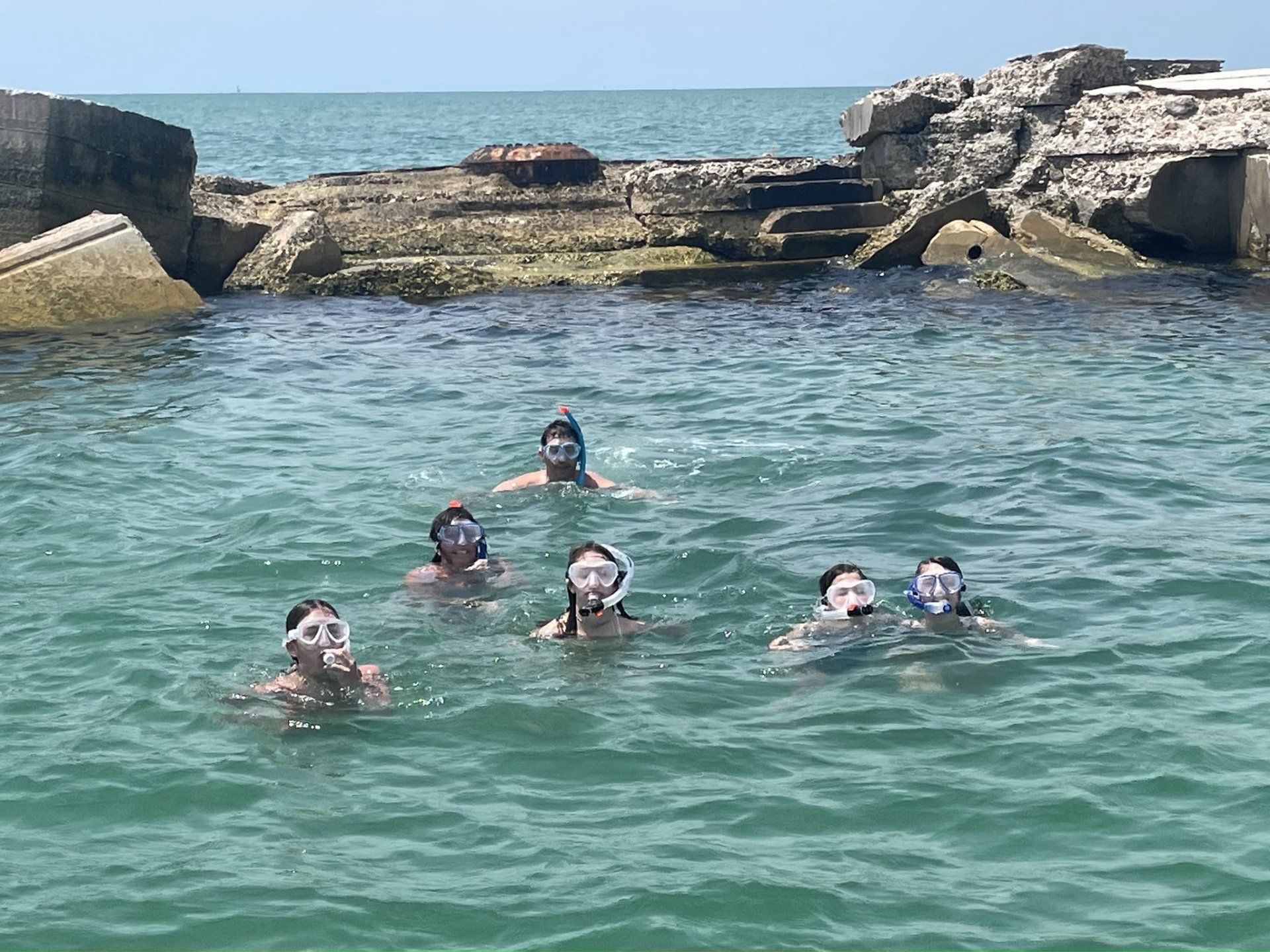 Family wearing goggles enjoying snorkeling tours