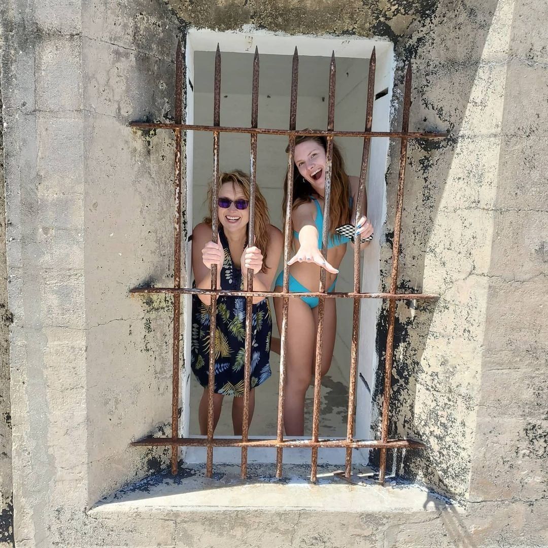 People in an old jail cell