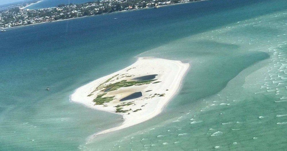 an island with clear water around it 