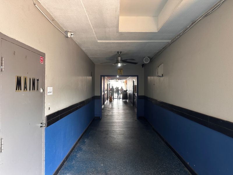 Hallway with blue wainscoting, gray walls