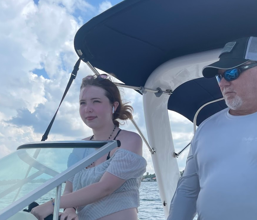 A man and a woman are standing on a boat