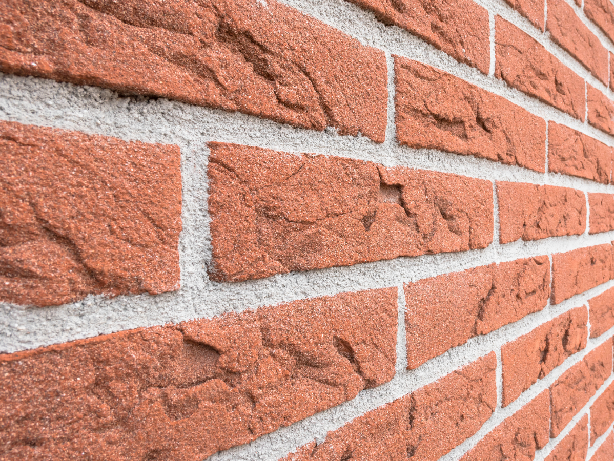 Red brick wall with white mortar.