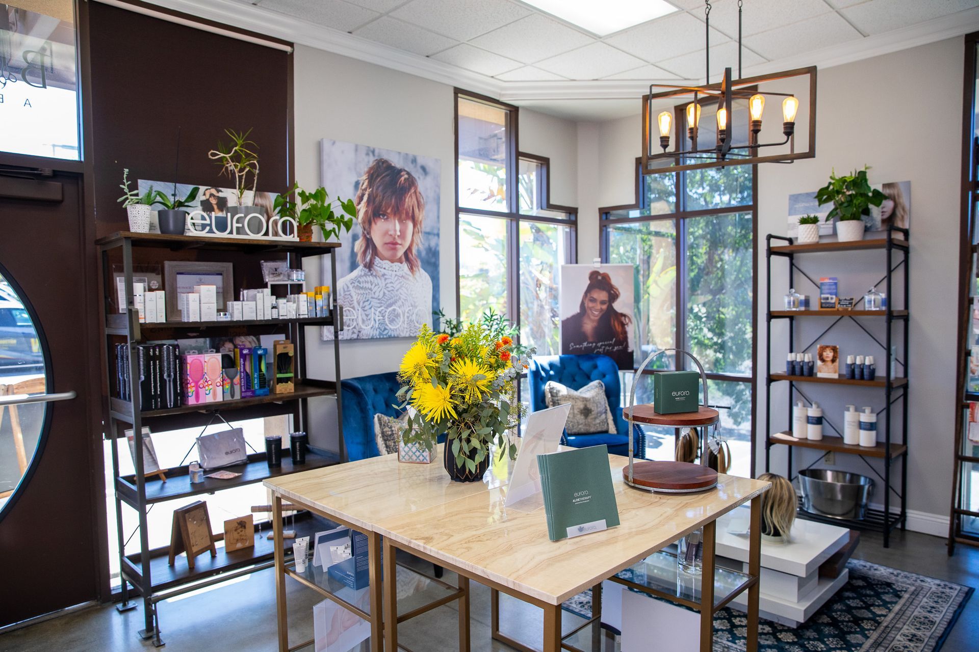 Interior of a hair and beauty salon. Retail display with shelves and table showcasing products.