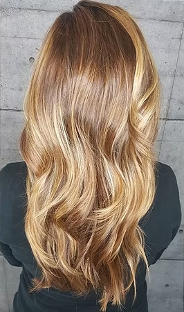 Long, wavy blonde and brown highlighted hair.