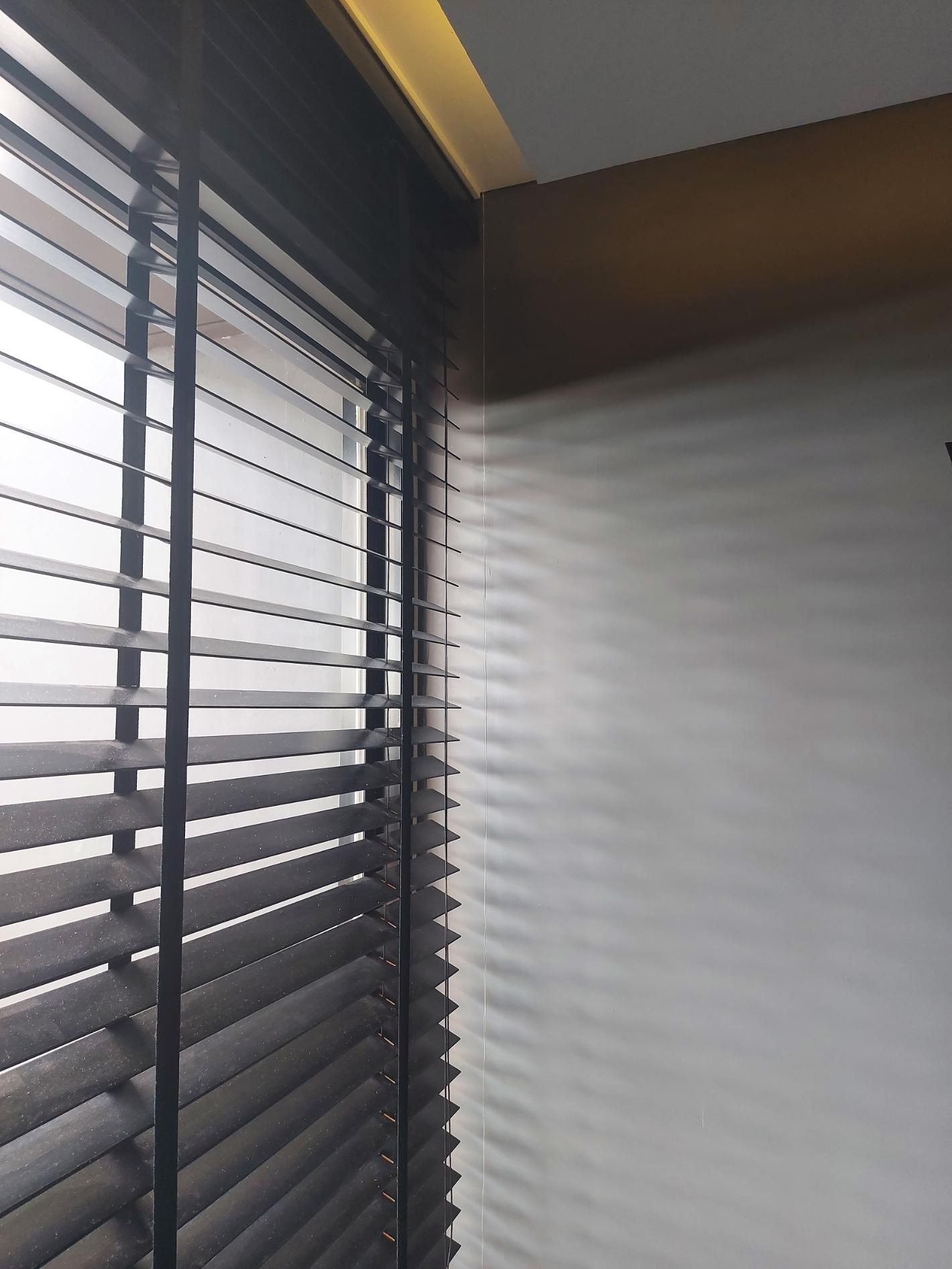 A close up of a window with blinds on it.