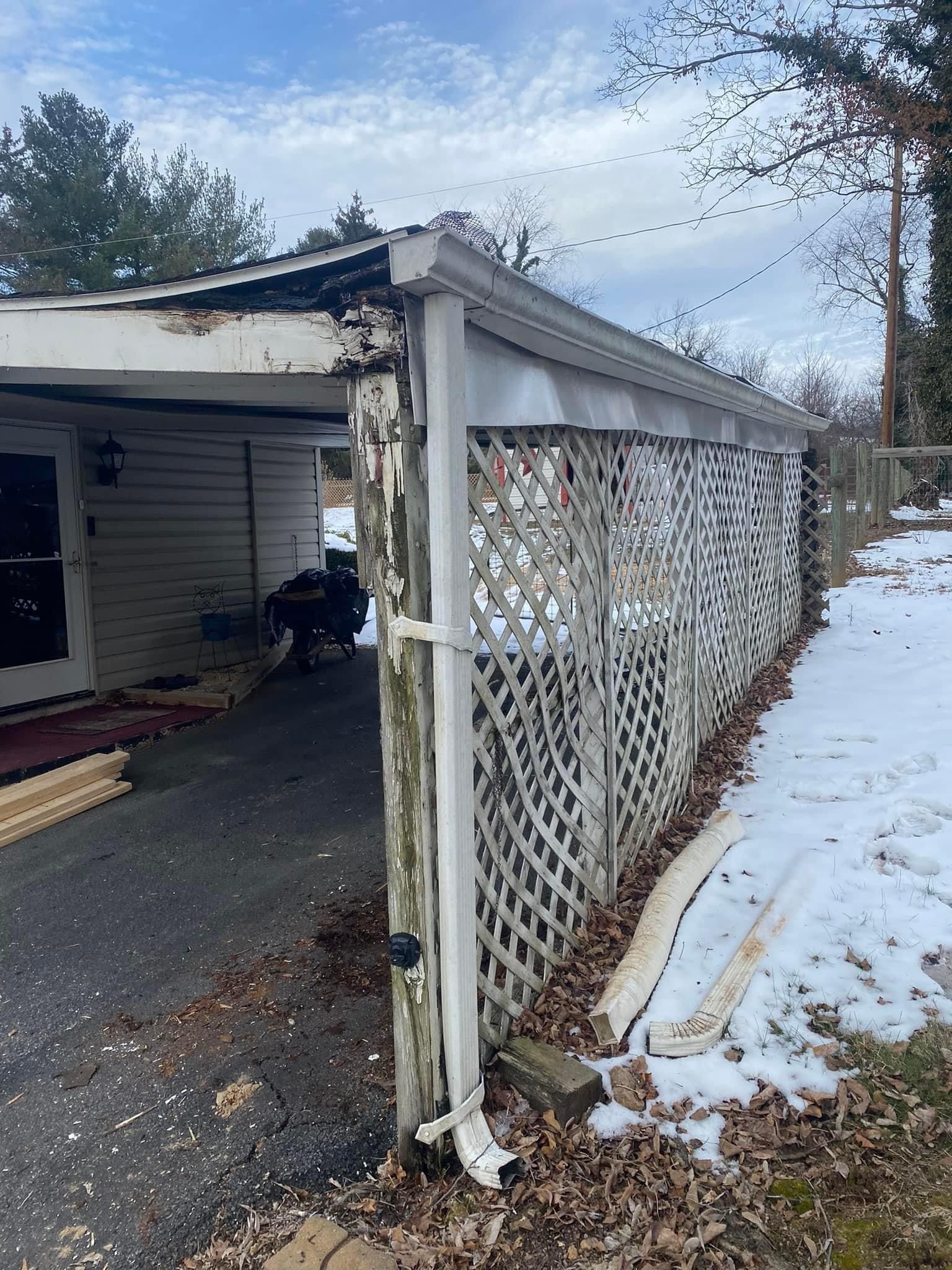 A white lattice fence is sitting next to a house in the snow — KP's Home Repair — McGaheysville, VA