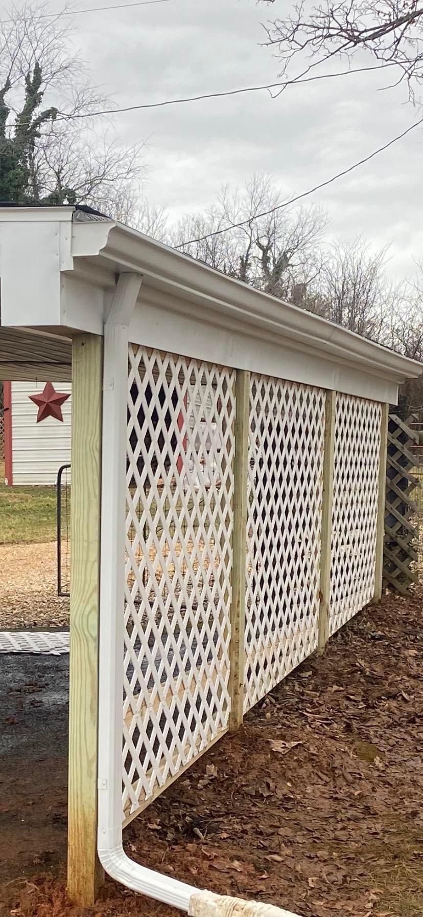 A white lattice fence with a drain pipe attached to it — KP's Home Repair — McGaheysville, VA