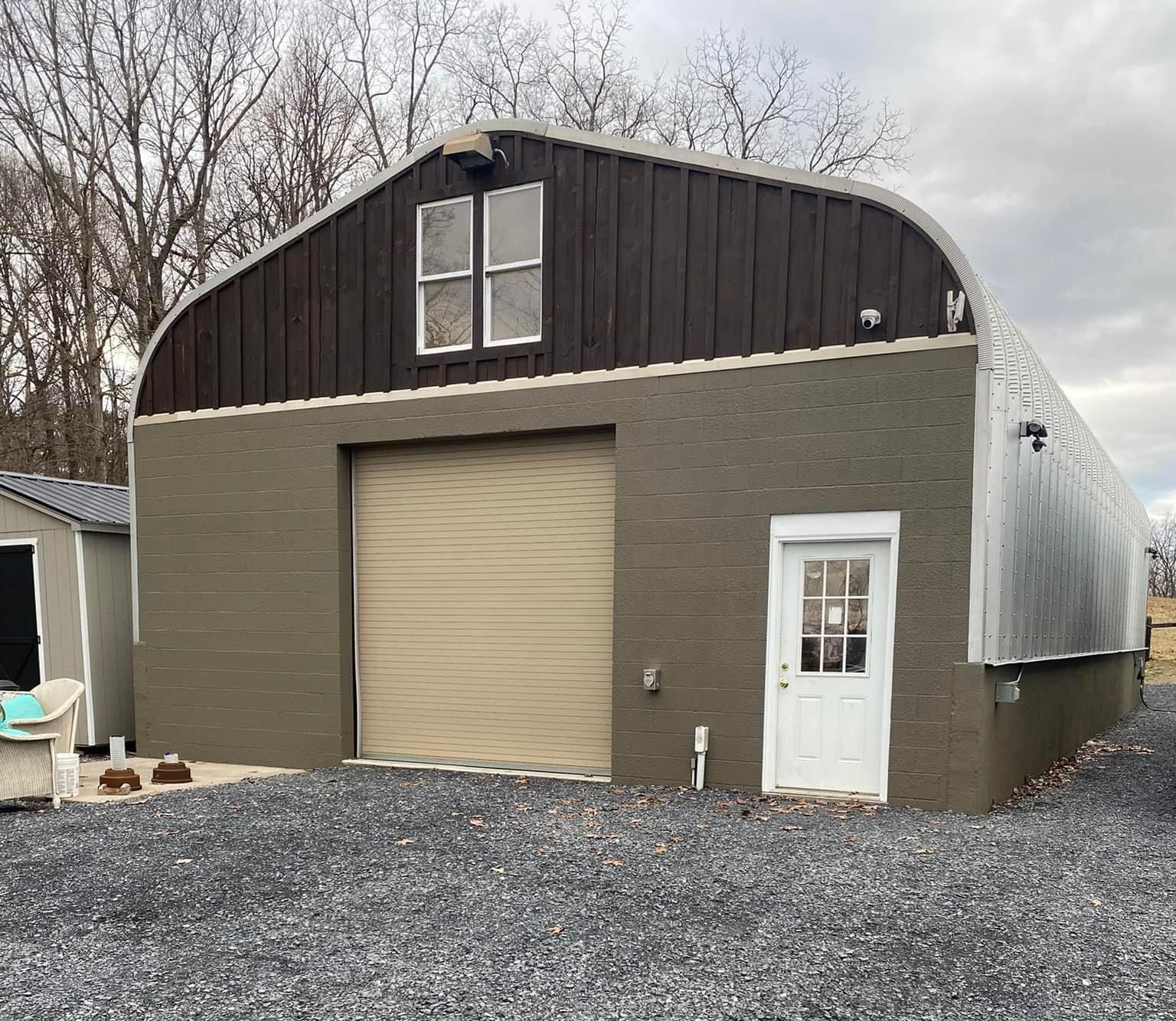 A large building with a garage door and a white door — KP's Home Repair — McGaheysville, VA