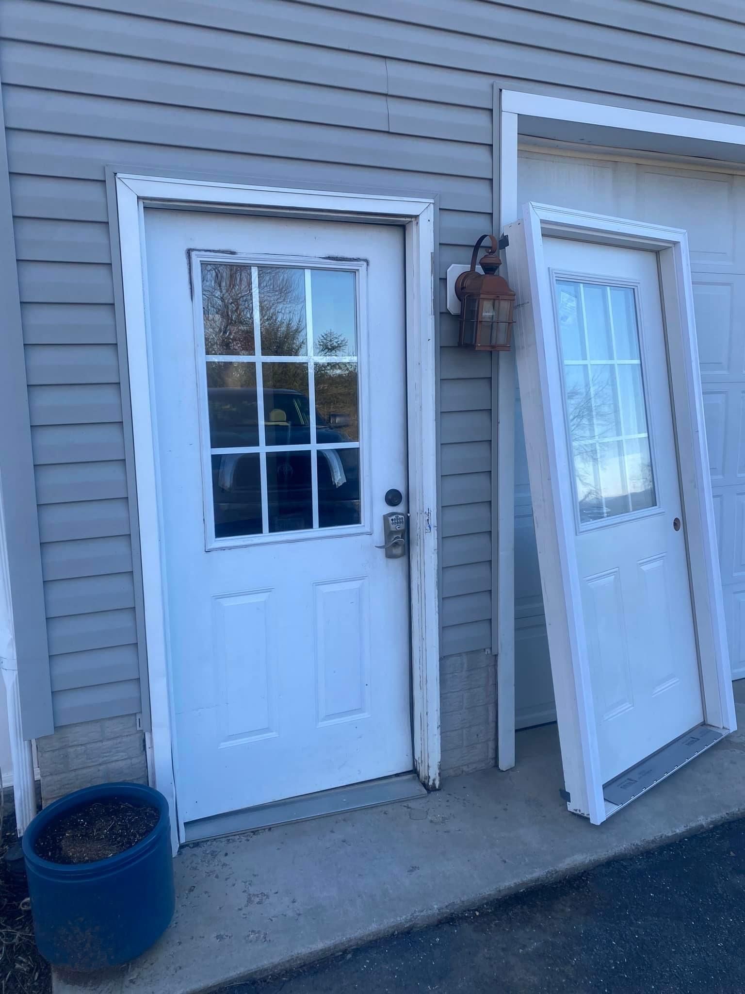 Two white doors are sitting next to each other on the side of a building — KP's Home Repair — McGaheysville, VA