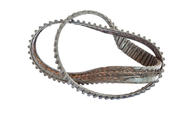 A close up of a rusty belt on a white background. | Autotrends - Irving Park