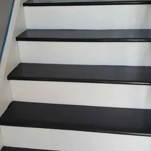 A close up of a set of black and white stairs