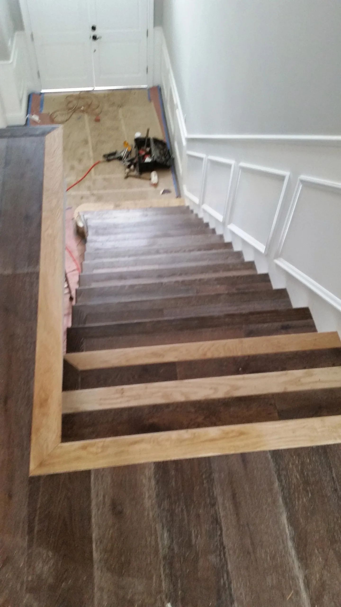 A wooden staircase is being built in a house