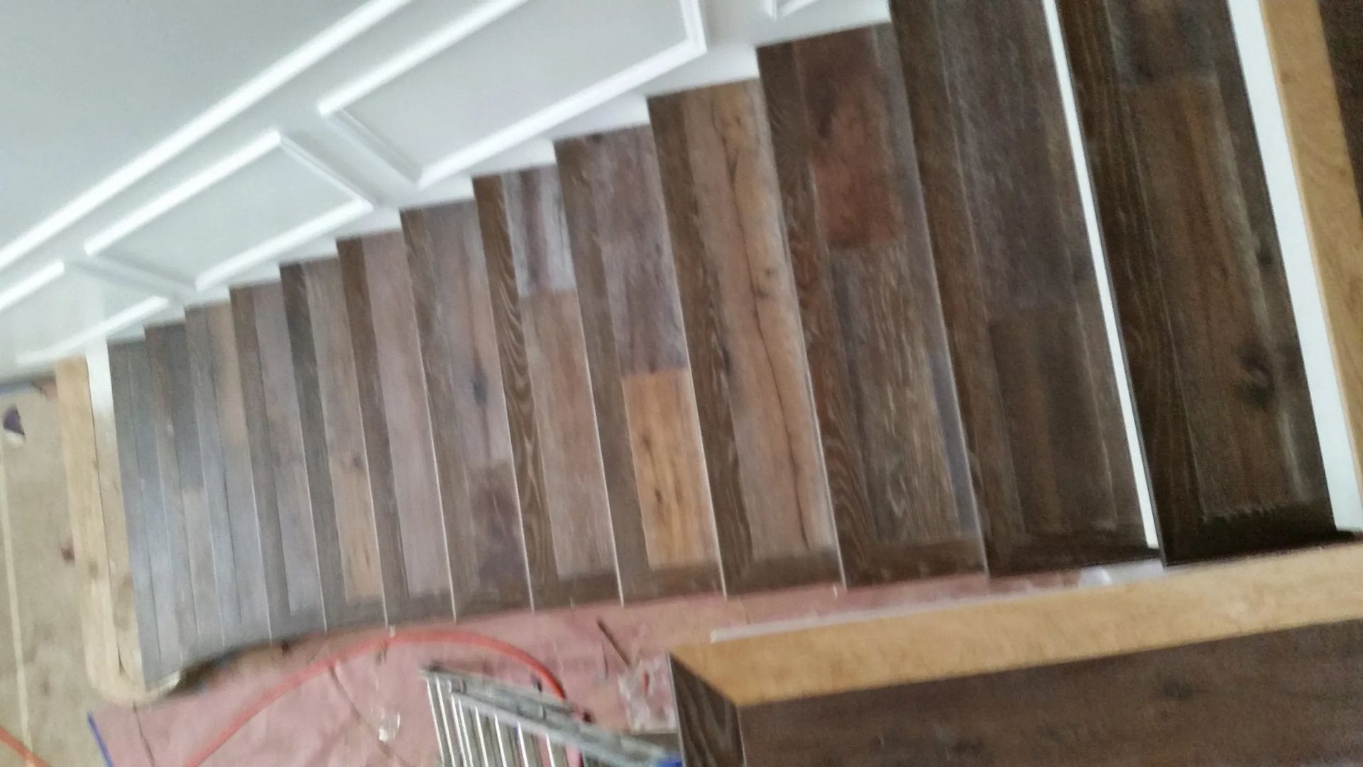 A wooden staircase is being built in a house