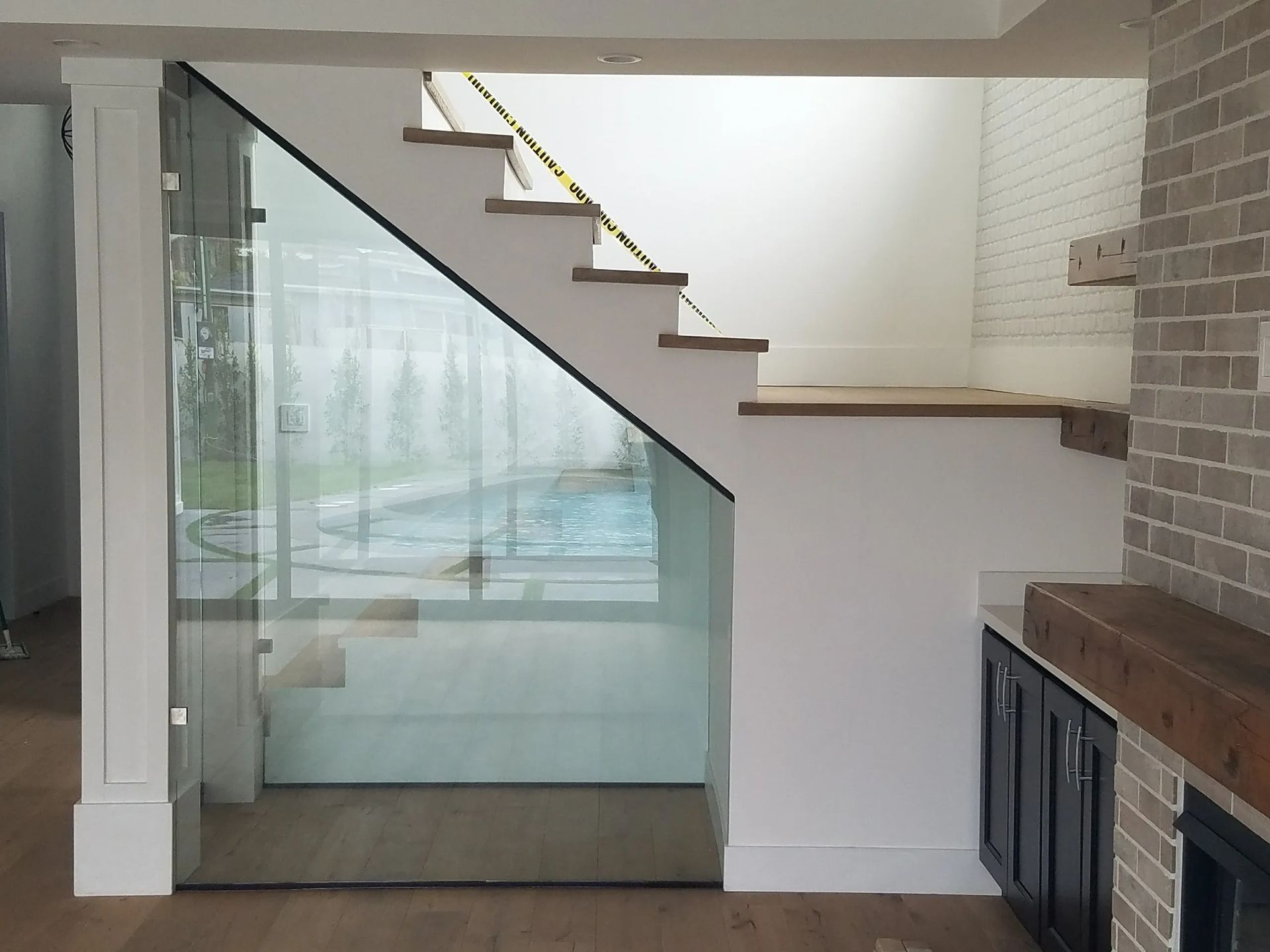 A staircase in a house with a glass railing