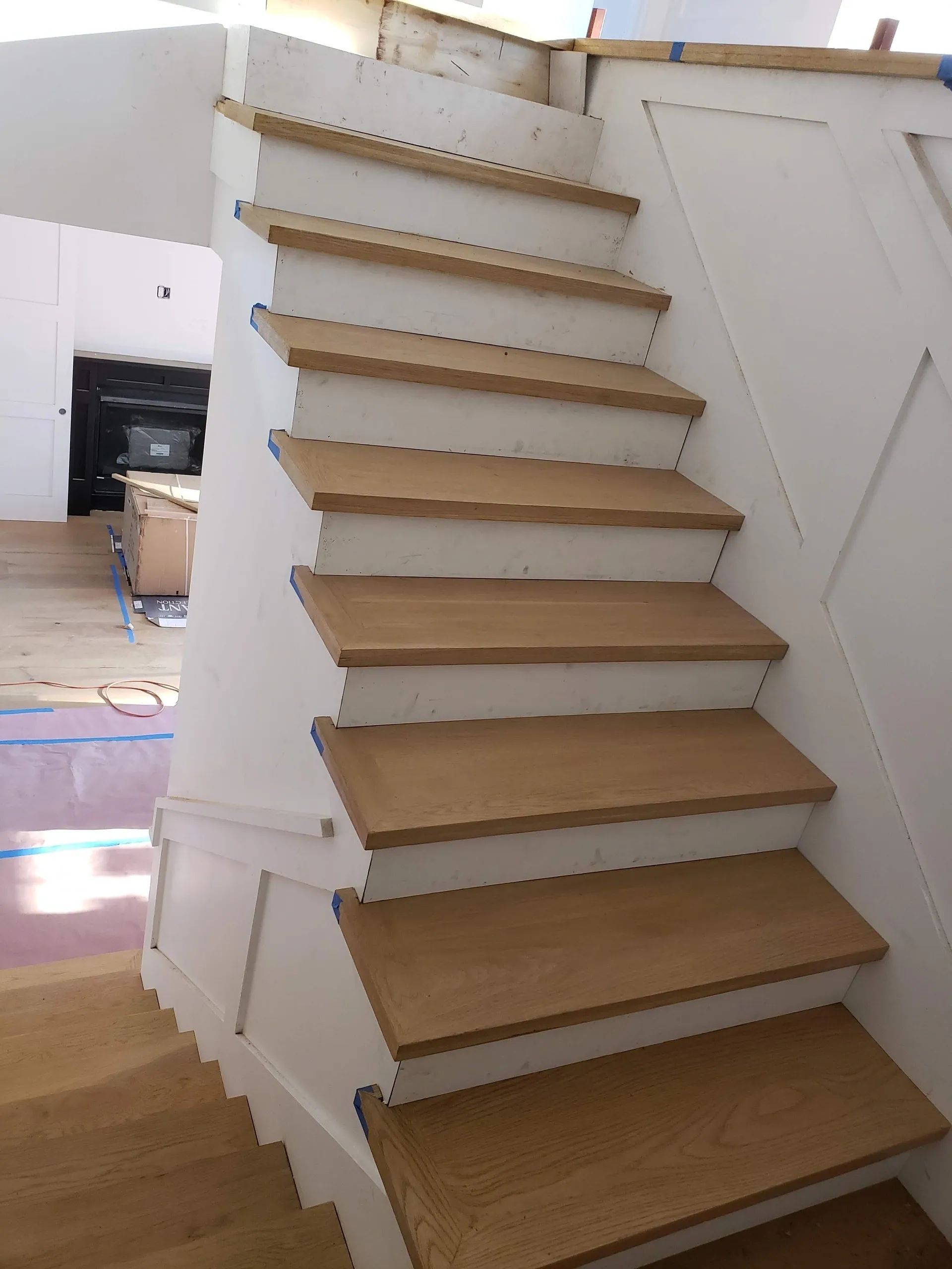 A staircase with wooden steps and a white railing