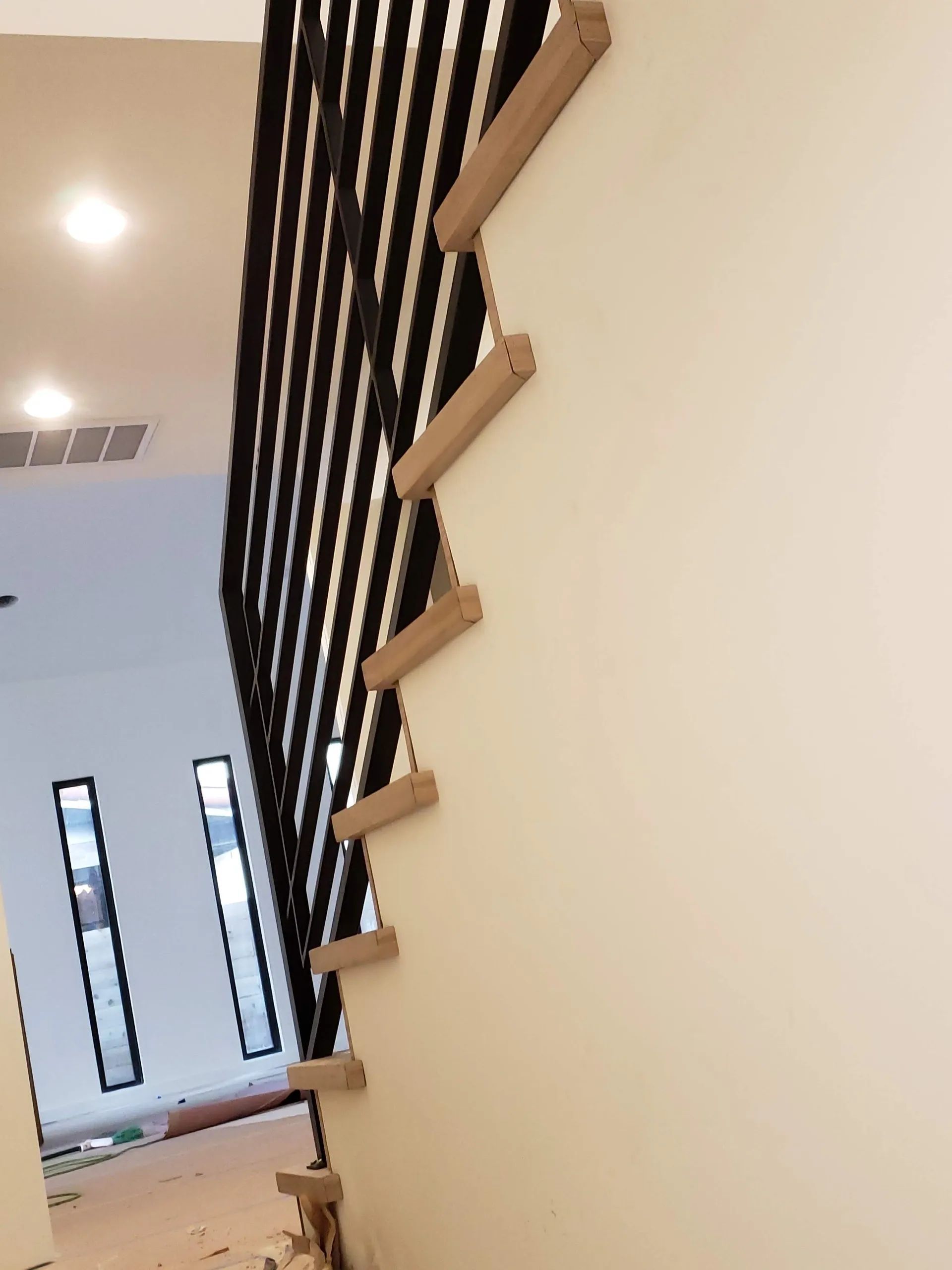 A staircase with wooden steps and a metal railing