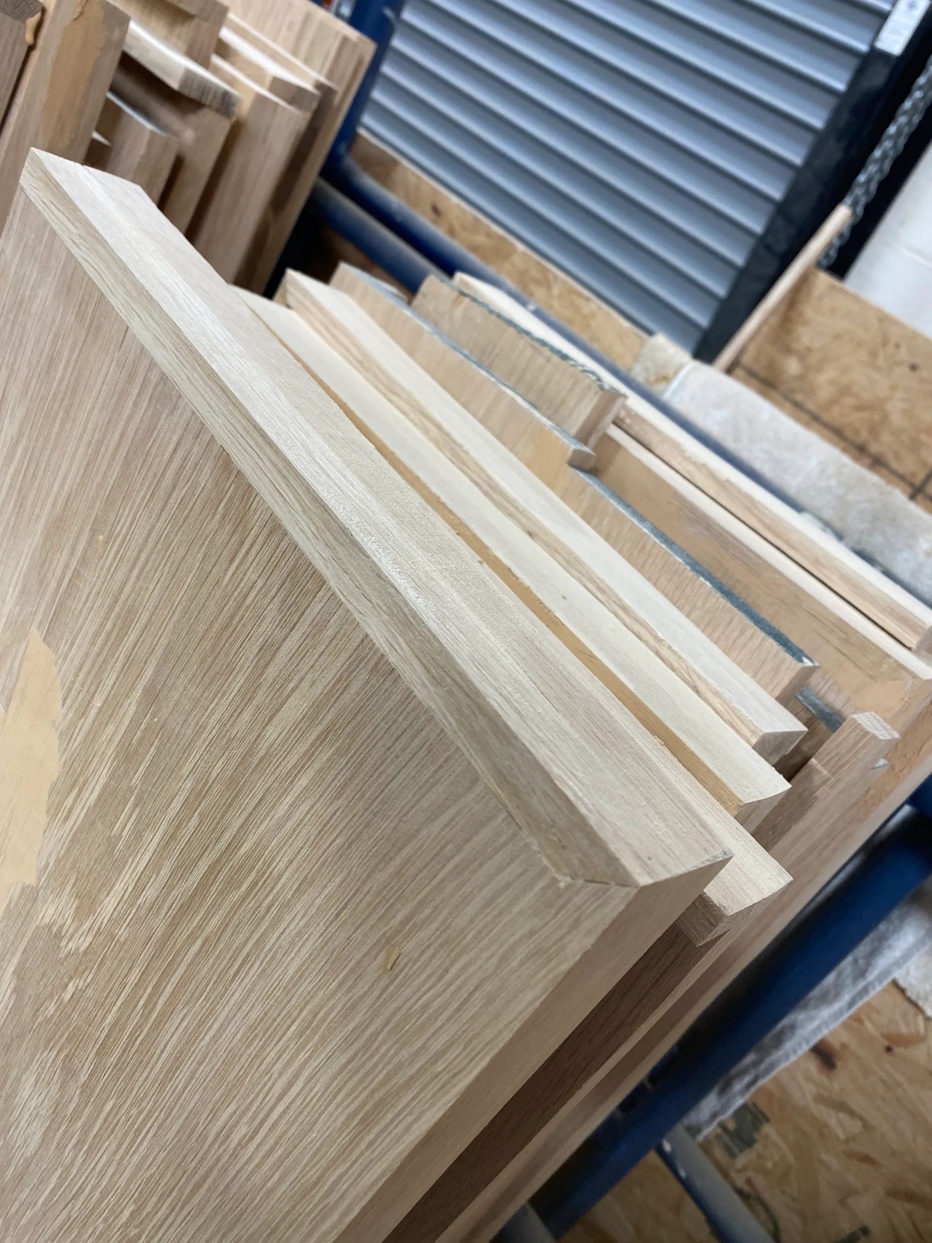 A pile of wood is stacked on top of each other in a warehouse