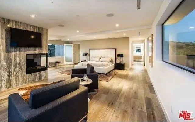 A living room with a couch a chair and a television