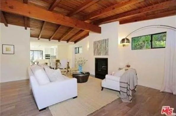A living room with a fireplace and a white couch