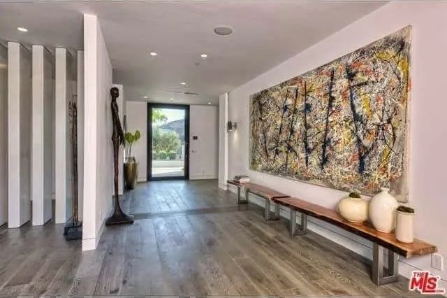 A hallway with a large painting on the wall