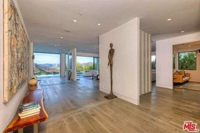 A hallway in a house with a statue in the middle